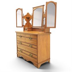 Edwardian satinwood dressing chest, rectangular moulded top over two short and two long drawers with brass drop handles, raised mirror back with arched central plate flanked by hinged side mirrors, small fitted trinket drawers and shaped pierced side supports with turned uprights