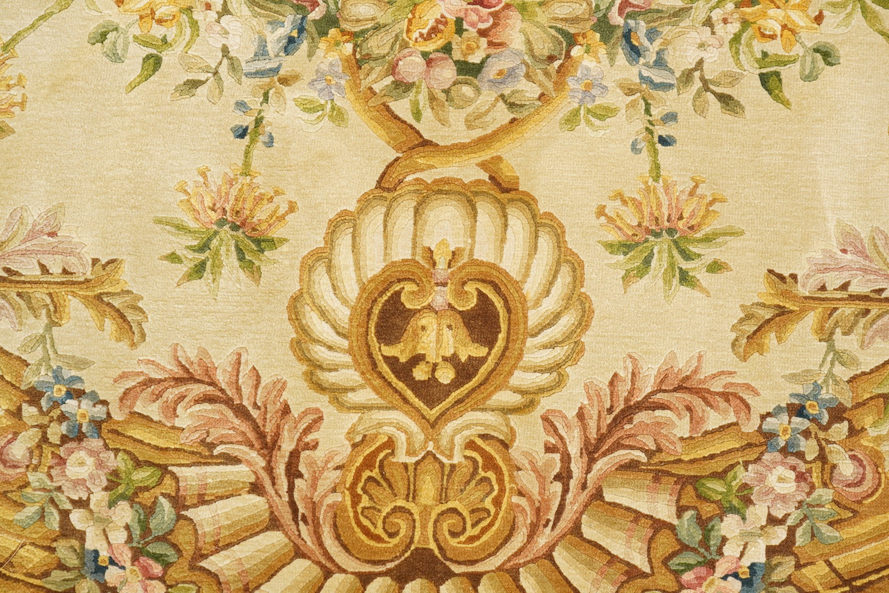 20th century French Aubusson style circular carpet, cream ground of Savonnerie design with scrolling floral and scallop motifs