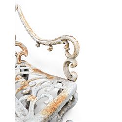 Pair of Victorian cast iron garden chairs, the ornate pierced back of scrolling foliate design, scrolling arm terminals over splayed supports formed of C and S-scrolls, in distressed white painted finish