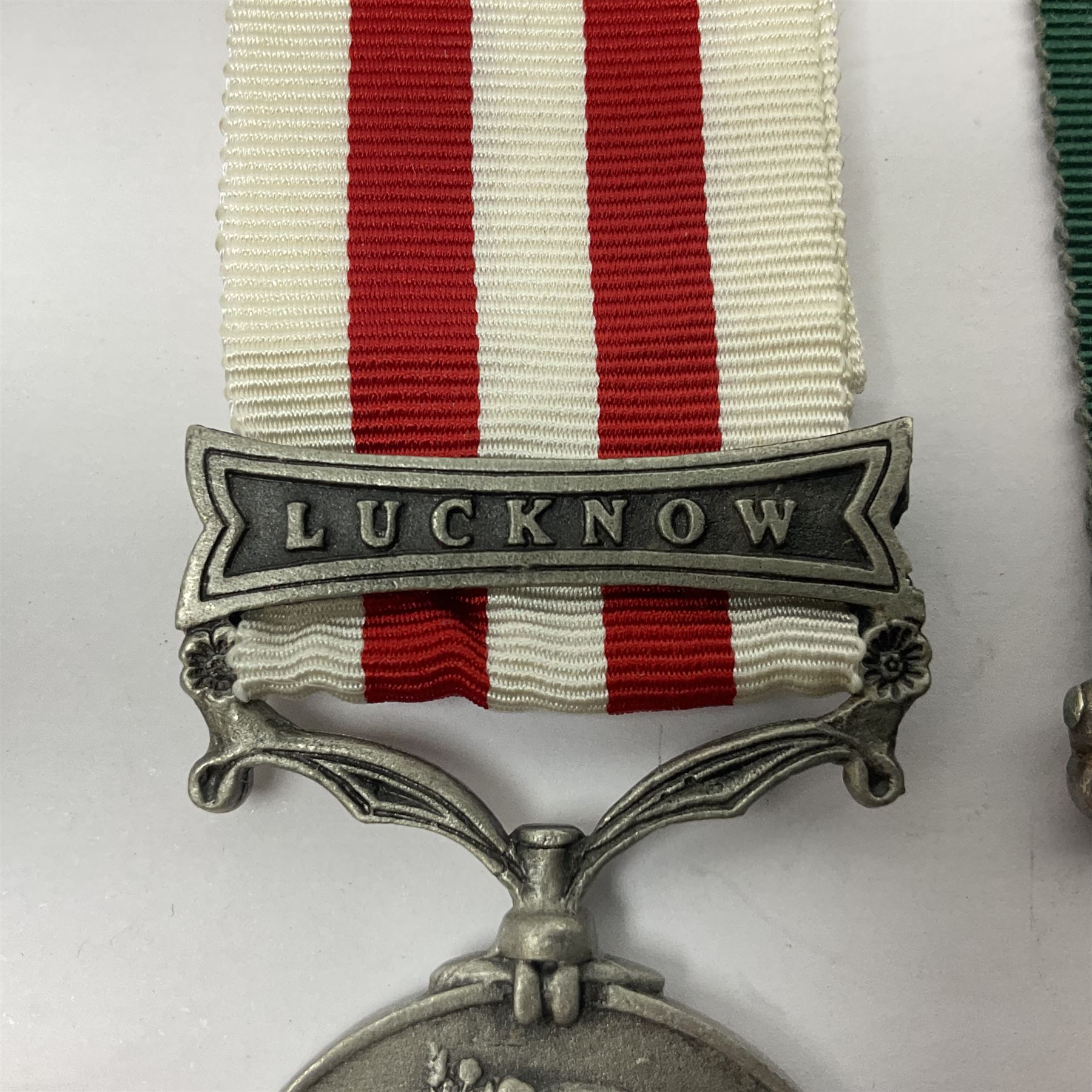 Victoria Long Service in the Volunteer Force Medal awarded to 369 Bombr. W. Woodward 1st Lincs. V.A.; and reproduction Victoria India Medal with Lucknow clasp; both with ribbons (2)