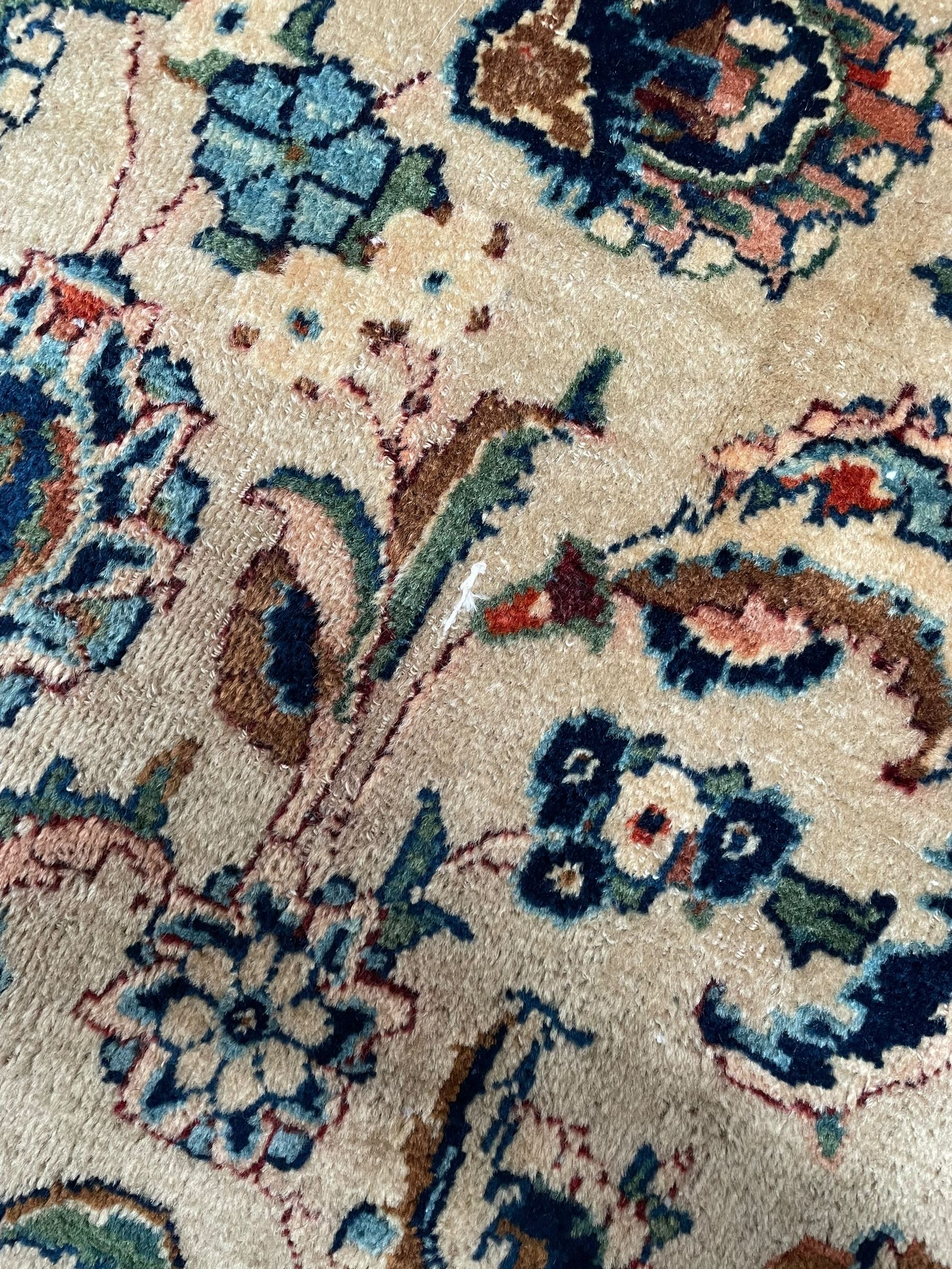 Persian Kashmar camel ground carpet, palmette rosette medallion on a field of curling leafy branches and stylised plant motifs, scrolling border decorated with further palmettes, within floral pattern guard stripes