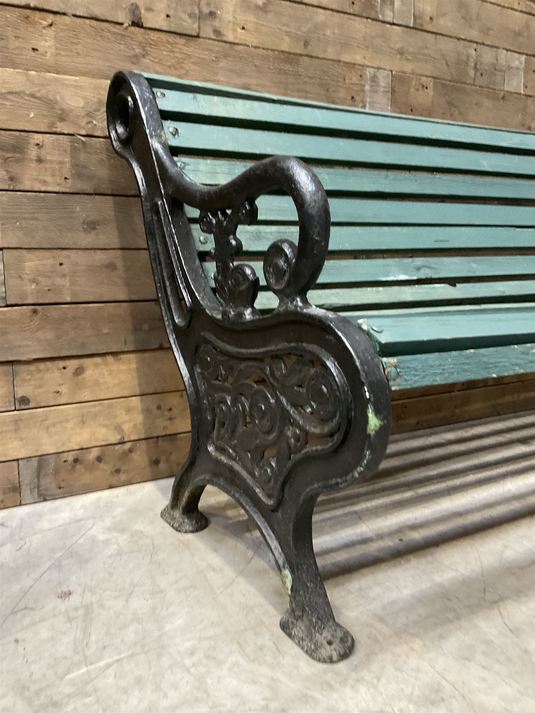 Early 20th century slatted garden bench with scrolling cast iron bench ends