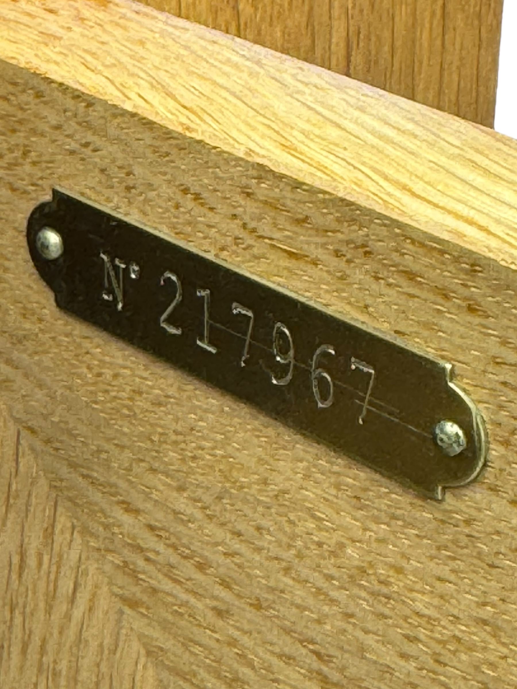 Contemporary light oak sideboard, chamfered rectangular top over two central bevel-edged drawers, flanked by two recessed panelled cupboards enclosing shelving, on square stile supports