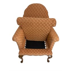 Georgian design walnut framed armchair, shaped back over scrolled arms, upholstered in coral lozenge patterned fabric over studded apron, on cabriole supports with shell decoration