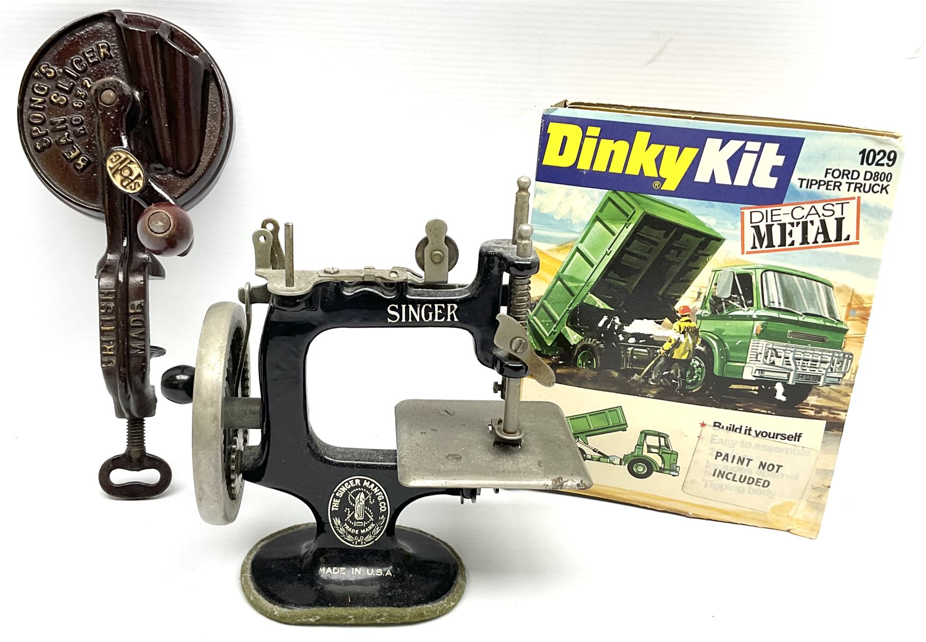 Dinky Kit No.1029 Ford D800 Tipper Truck in unopened original packaging; American Singer child's sewing machine; Spong's table mounting Bean Slicer No.632; and two wall mounting wooden die-cast model open display racks (5)