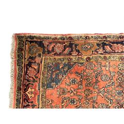 Persian Zanjan pale red ground rug, lozenge medallion and field decorated with floral Herati motifs, the border decorated with stylised plant motifs and trailing branches, floral pattern guard stripes