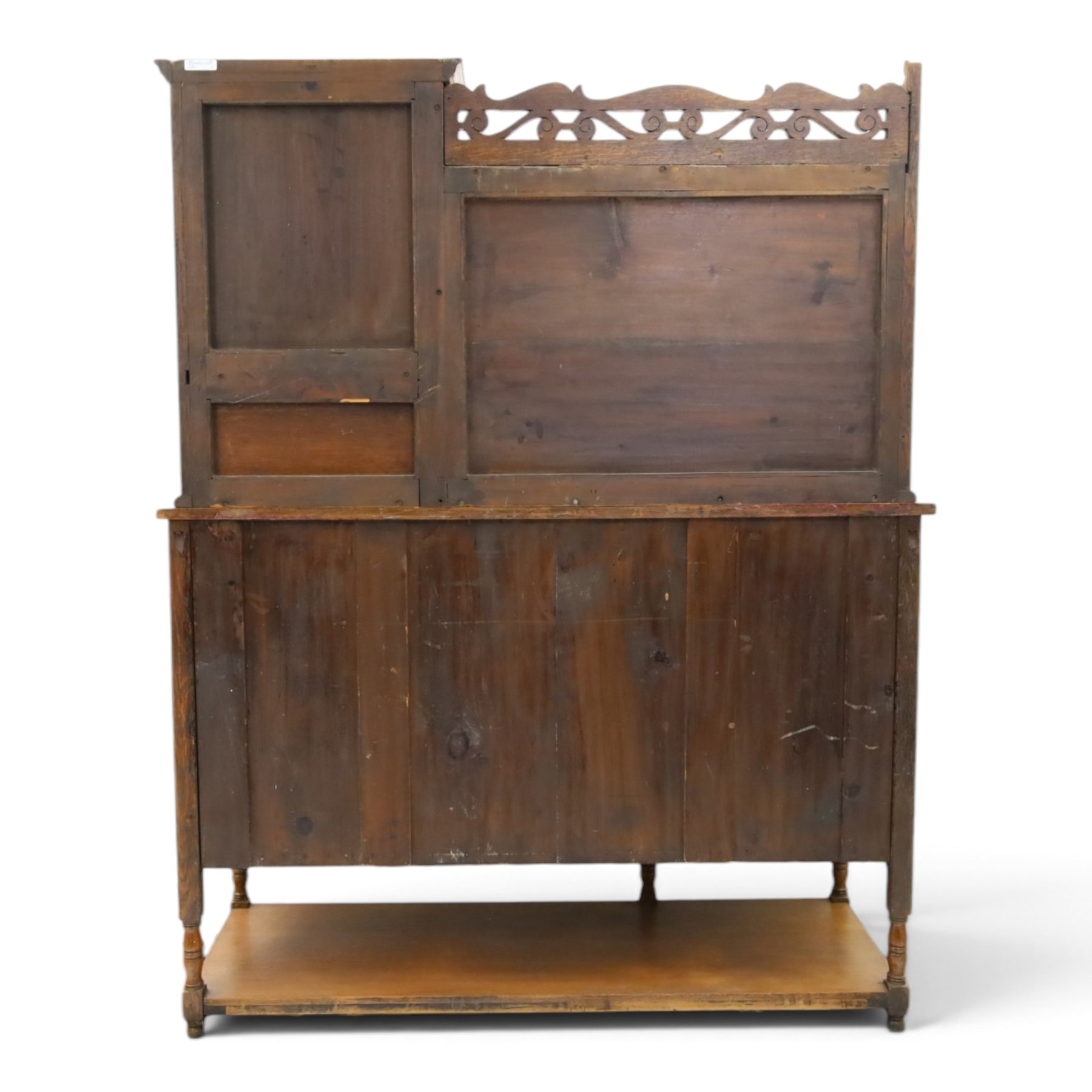 Maple & Co. - Arts & Crafts oak dresser with stained glass cupboard, raised section with pierced pediment above a mirrored back, with a stained glass fronted cupboard with fixed shelf, single long drawer, above a pair of fielded panels, with open recess above a short drawer, raised above a full length undertier with turned supports