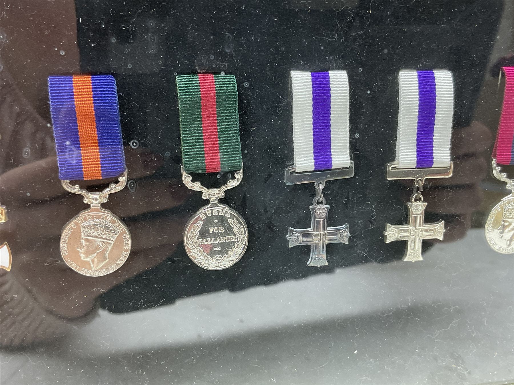 Limited edition large framed display board with sixty half-size copies of British Gallantry and Campaign Medals produced by Danbury Mint; all with ribbons and associated booklet