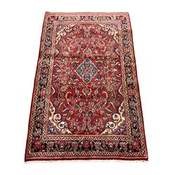 Persian Hamadan red ground rug, the field decorated with interlaced foliate and flower head motifs, repeating guarded border 