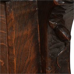 Mouseman - circa. 1920s adzed oak settle or bench, the cresting rail carved with inscription 'Before Honour is Humility', four panel back and plank seat on shaped end supports carved with grotesque masks terminals, carved with mouse signature, by Robert Thompson of Kilburn 
