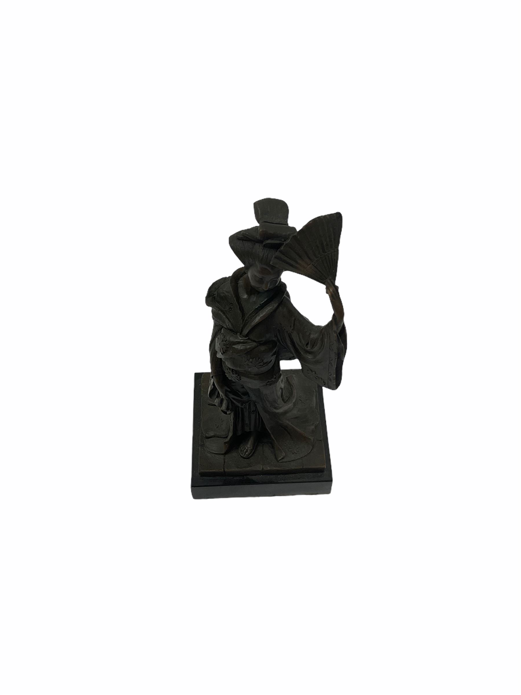 A Japanese bronze modelled of a Geisha, impressed Kamiko, upon slate base, H25cm. 