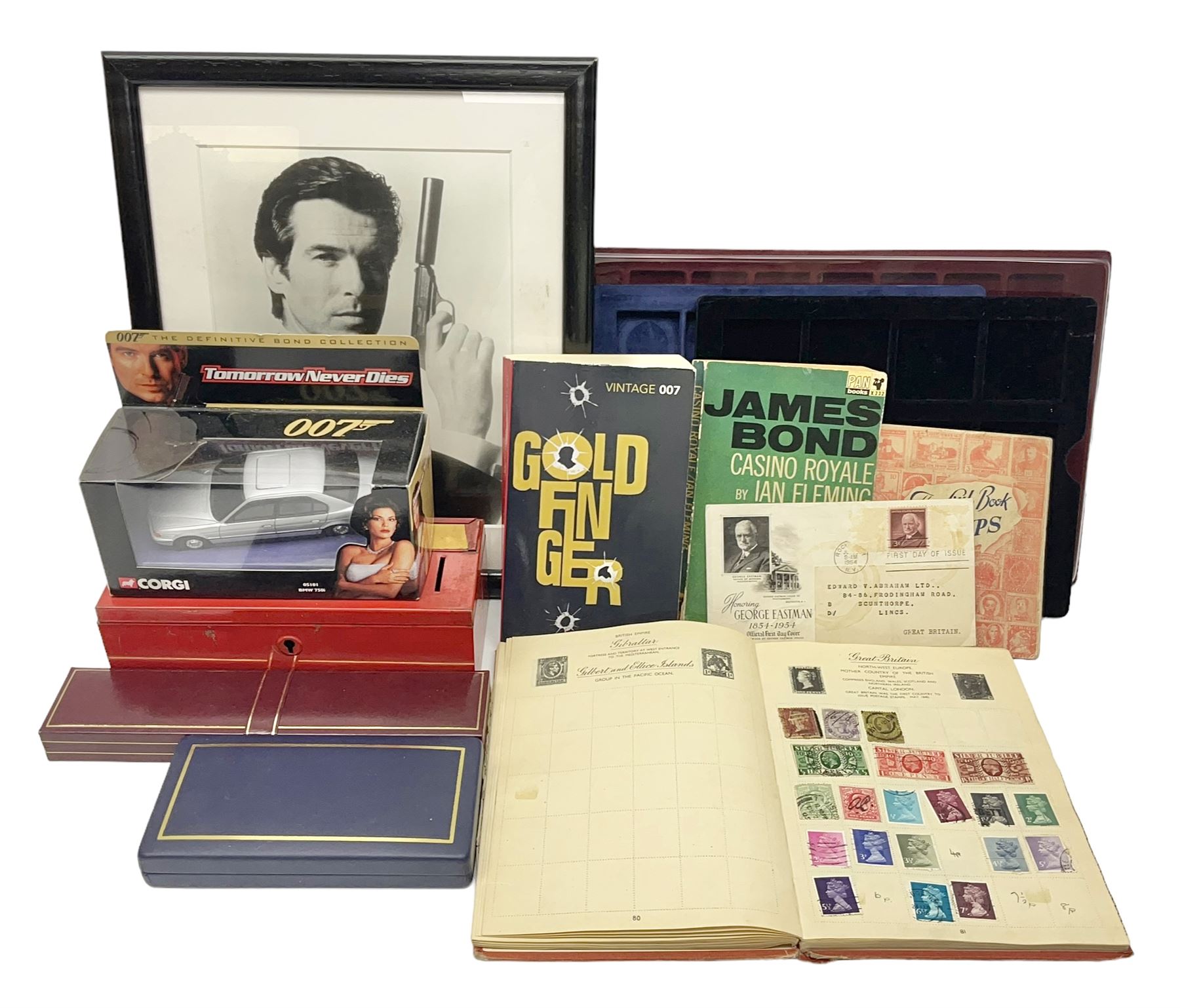 Pierce Brosnan framed picture, James Bond books, Corgi Tomorrow Never Dies BMW 750i model, small number of stamps, empty coin displays and other miscellaneous items