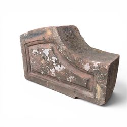 Pair of 19th century hewn and carved stone wall ends, the facias carved as shaped faux fielded panels