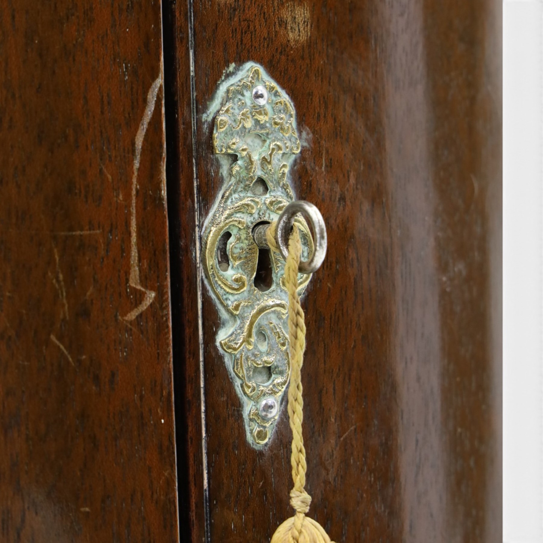 Small Georgian mahogany cylindrical hanging corner cabinet, projecting cornice with dentil carving, brass H hinges and escutcheons
