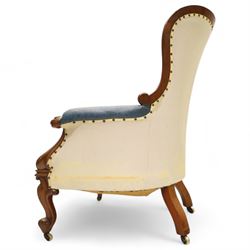 Fine pair of mid-19th-century mahogany library armchairs, carved frame with balloon-shaped back with scrolled ends, rolled wide arms, ending in a scrolled volute above a serpentine seat rail, upholstered in mottled turquoise faux leather, button upholstered back, arms, and cushion seat, studded sides and apron, raised on scroll carved front feet and splayed rear legs on castors 