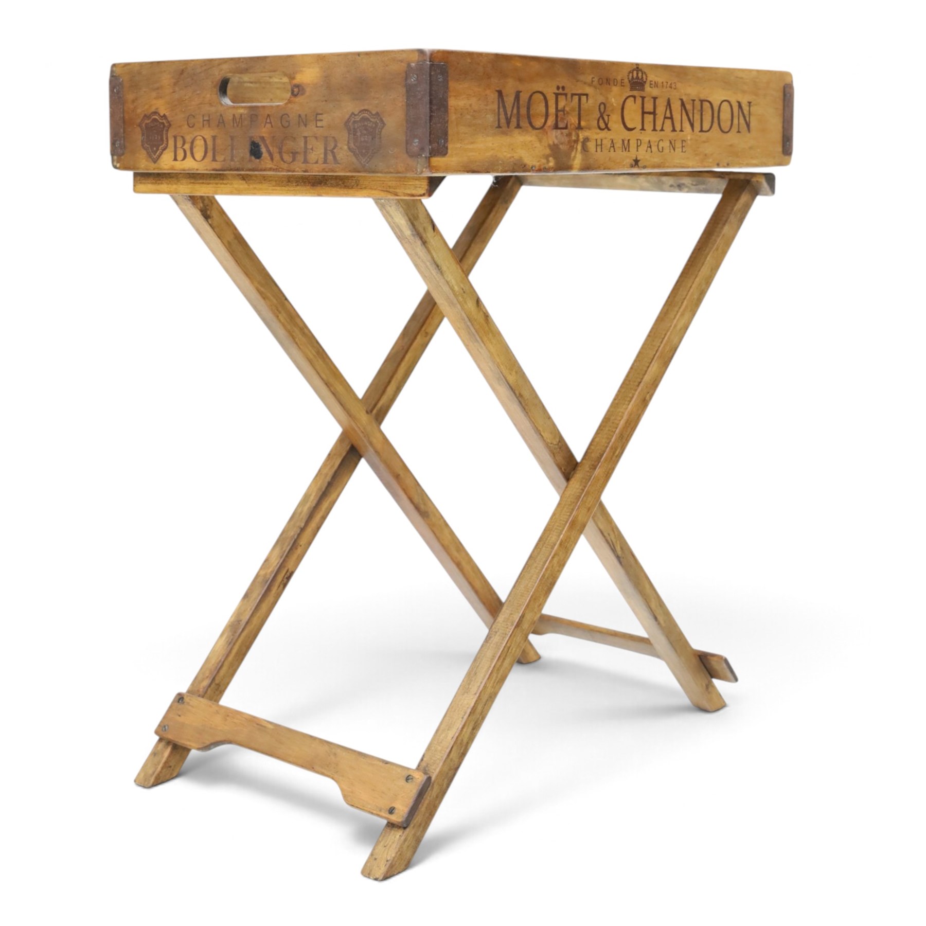 Champagne butler’s tray on stand, the wooden tray printed with champagne bottles and brand names, with cutout handles, raised on a folding stand