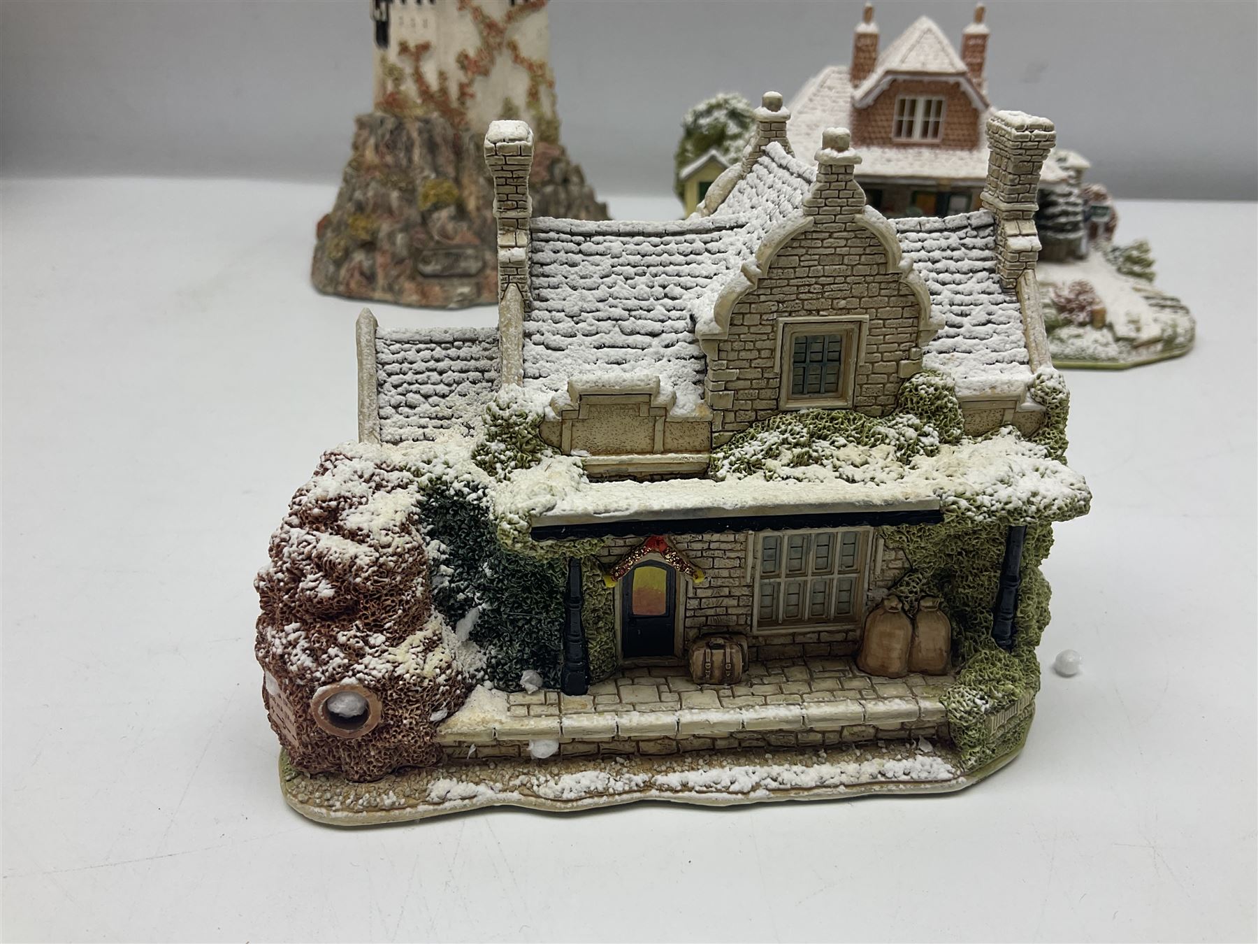 Five Lilliput Lanes, comprising Christmas at Woody Bay Station and Calling Home for Christmas both from the Illuminated collection, Castle of the Exiled Prince, Castle of The Ransomed King and Helvellyn, all with original boxes (5)