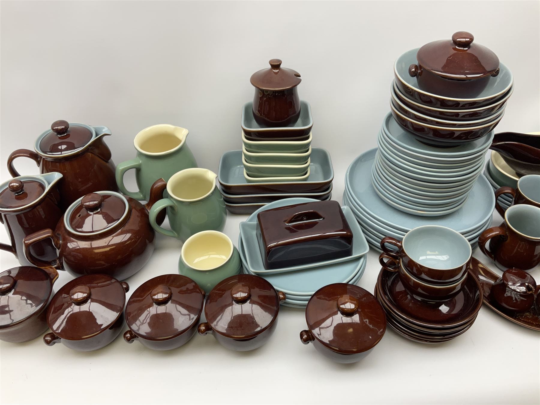 Denby dinner and tea wares, comprising largely Homestead pattern, to include dinner plates, salad plates, serving plates and dishes, bowls, teapot, coffee pot, hot water pot, teacups, saucers, milk jug, etc. 