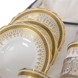 Boxed set of six Aynsley coffee cans and saucers, decorated with gilt greek key border, the cans within silver mounts, hallmarked Birmingham 1911
