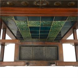 Shapland & Petter of Barnstaple - Arts & Crafts mahogany tile-backed umbrella or stick hall-stand, model no.114, the shaped back with single shelf over an Art Nouveau embossed patinated copper panel and turquoise tiled back, with turned supports and dividers over inset metal drip tray

Notes: A comparable Shapland & Petter stick stand of this model is recorded in Daryl Bennett, Shapland & Petter Ltd of Barnstaple, Museum of Barnstaple and North Devon, p.84, cat. no.5.37, and the model is also listed in Bennett, Liberty’s Furniture 1875-1915, p.298, cat. no.8.6. Examples of this model are known to have been retailed by Liberty & Co.