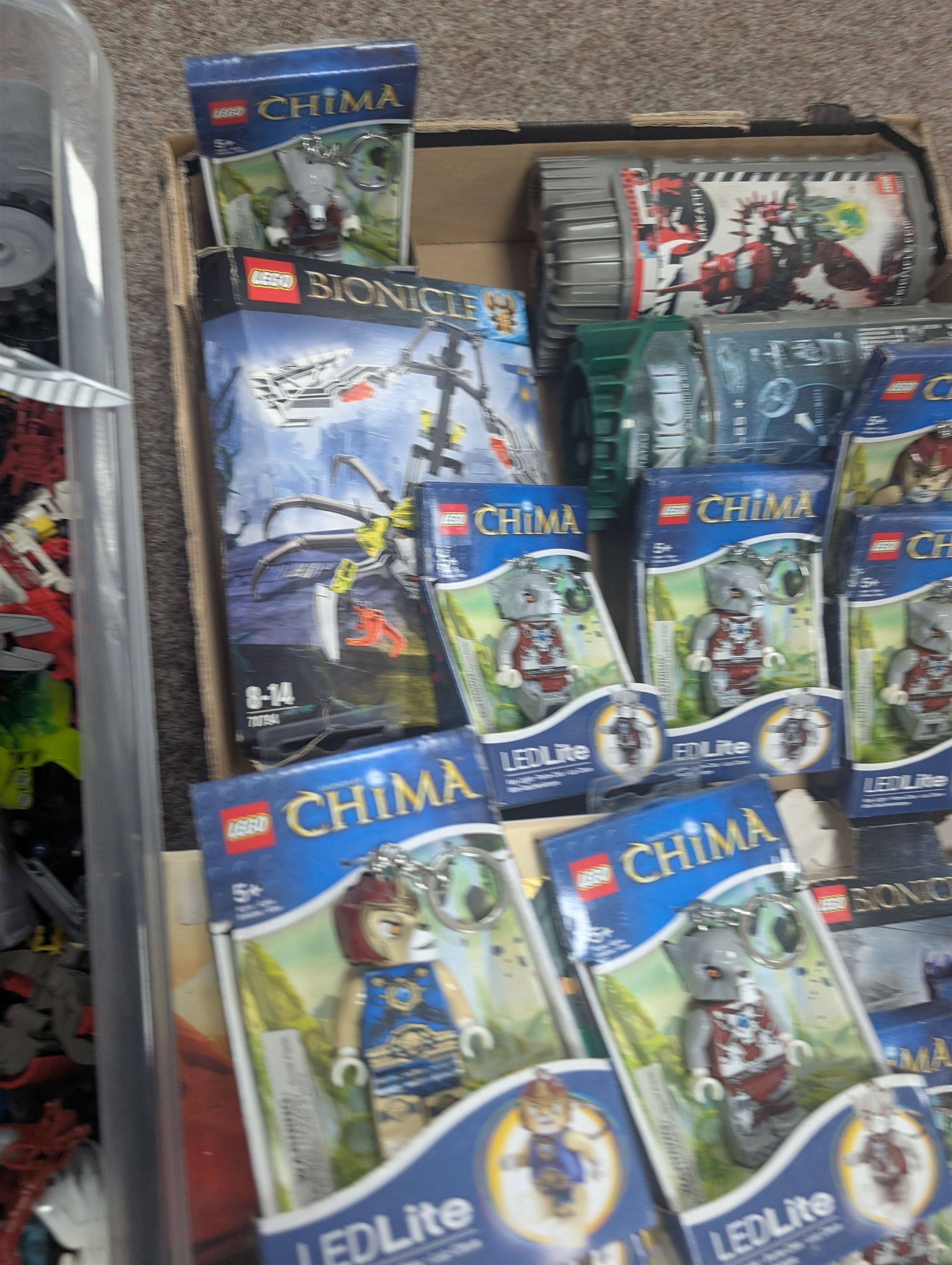 Lego Bionicle and similar part built figures and parts, including boxed sets and loose, together with a Lego Ninjago Build Your Own Adventure set and ten LEDlite Legends of Chima keyrings