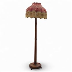 Early 20th century mahogany standard lamp, the turned column raised on a circular stepped ...
