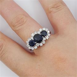 18ct white gold three stone oval and round cut sapphire and round brilliant cut diamond cluster ring, London 1986, total sapphire weight approx 1.80 carat, total diamond weight approx 0.60 carat