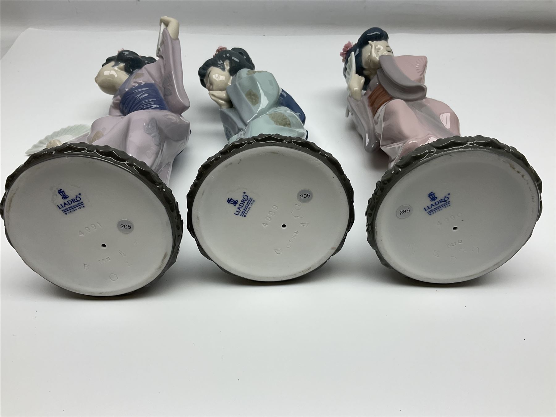 Three Lladro Japanese figures, comprising Sayonara no. 4989, Chrysanthemum no. 4990 and Madame Butterfly no. 4991, largest H30cm