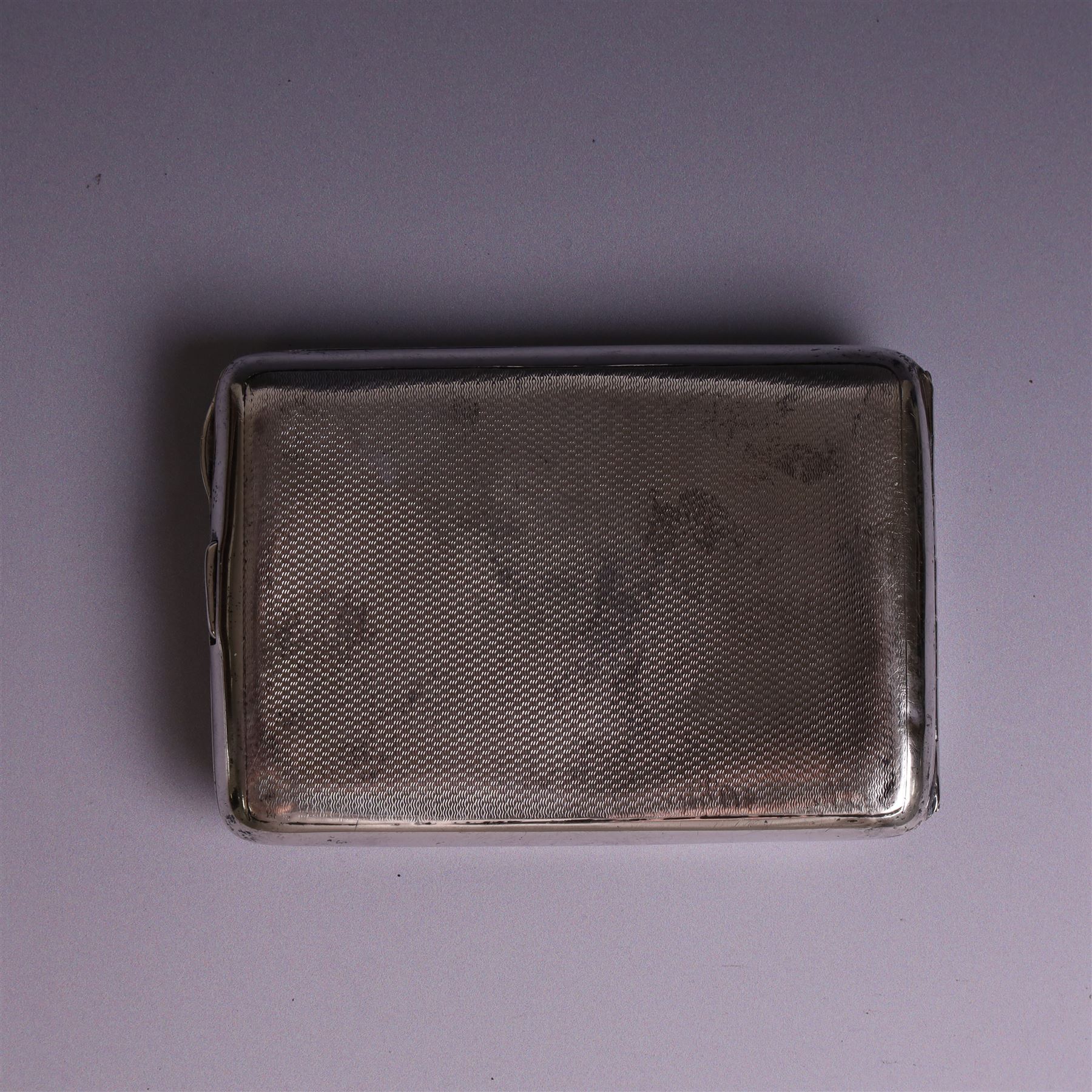 1930s silver cigarette case, of curved rectangular form with engine turned decoration and vacant cartouche, hallmarked Joseph Gloster Ltd, Birmingham 1934 and a 1930s silver sweetheart compact with engine turned decoration and enamel Royal Engineers crest, hallmarked Crisford & Norris Ltd, Birmingham 1939, cigarette box L12cm, H8cm
