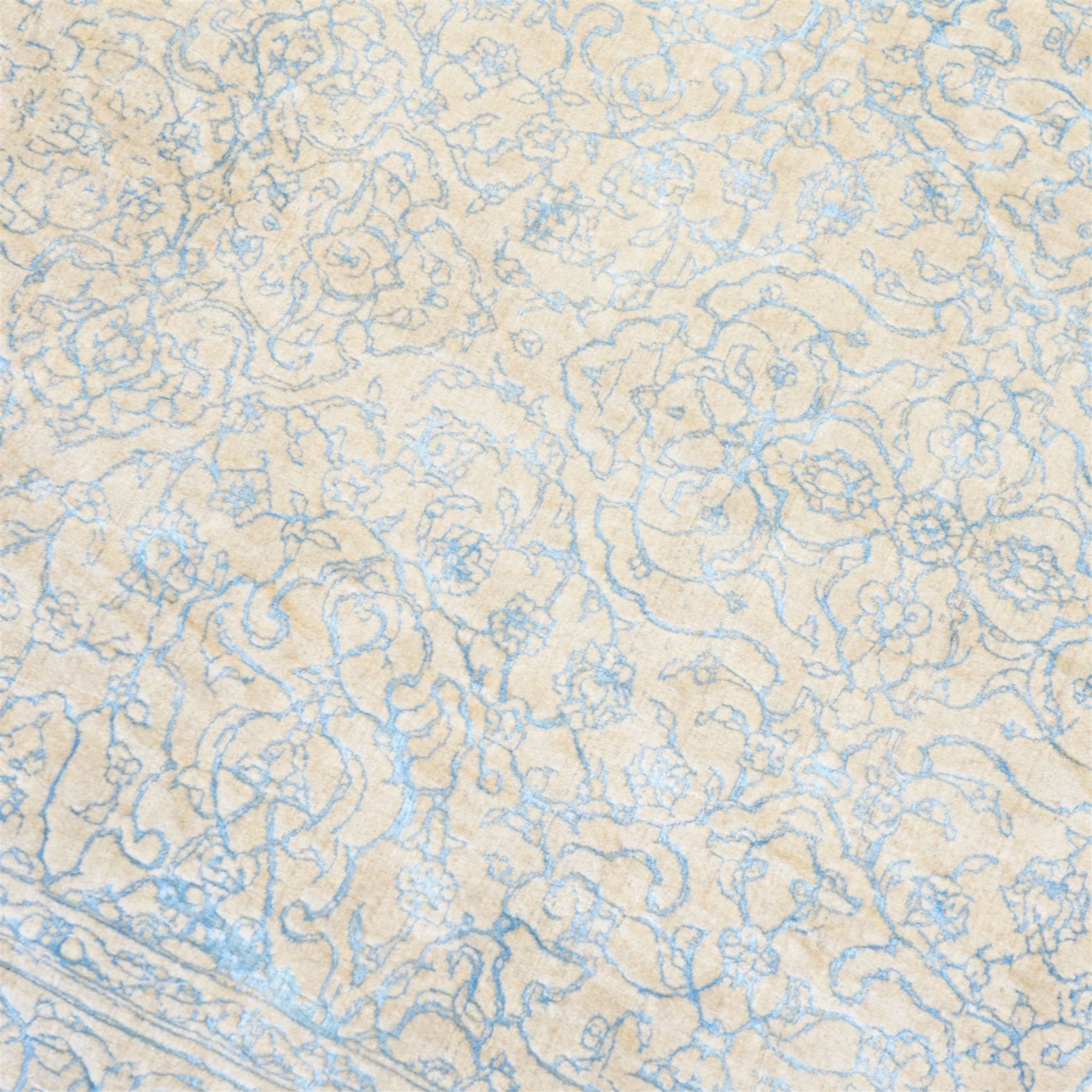 Large cream ground carpet, with overall arabesque design in light blue, within scrolling border 