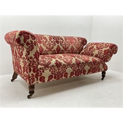 Late Victorian two seat traditional shape settee, adjustable staggered drop end, hardwood framed, upholstered in red and pale gold fabric with raised stylised floral pattern, turned oak front supports and splayed walnut rear supports with brass and ceramic castors