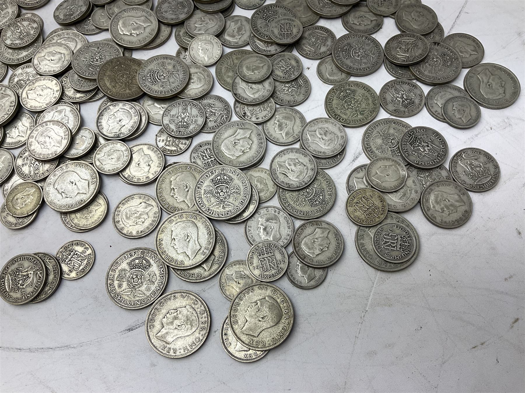 Approximately 1460 grams of pre 1947 Great British silver coins, including sixpences, shillings and two shillings 