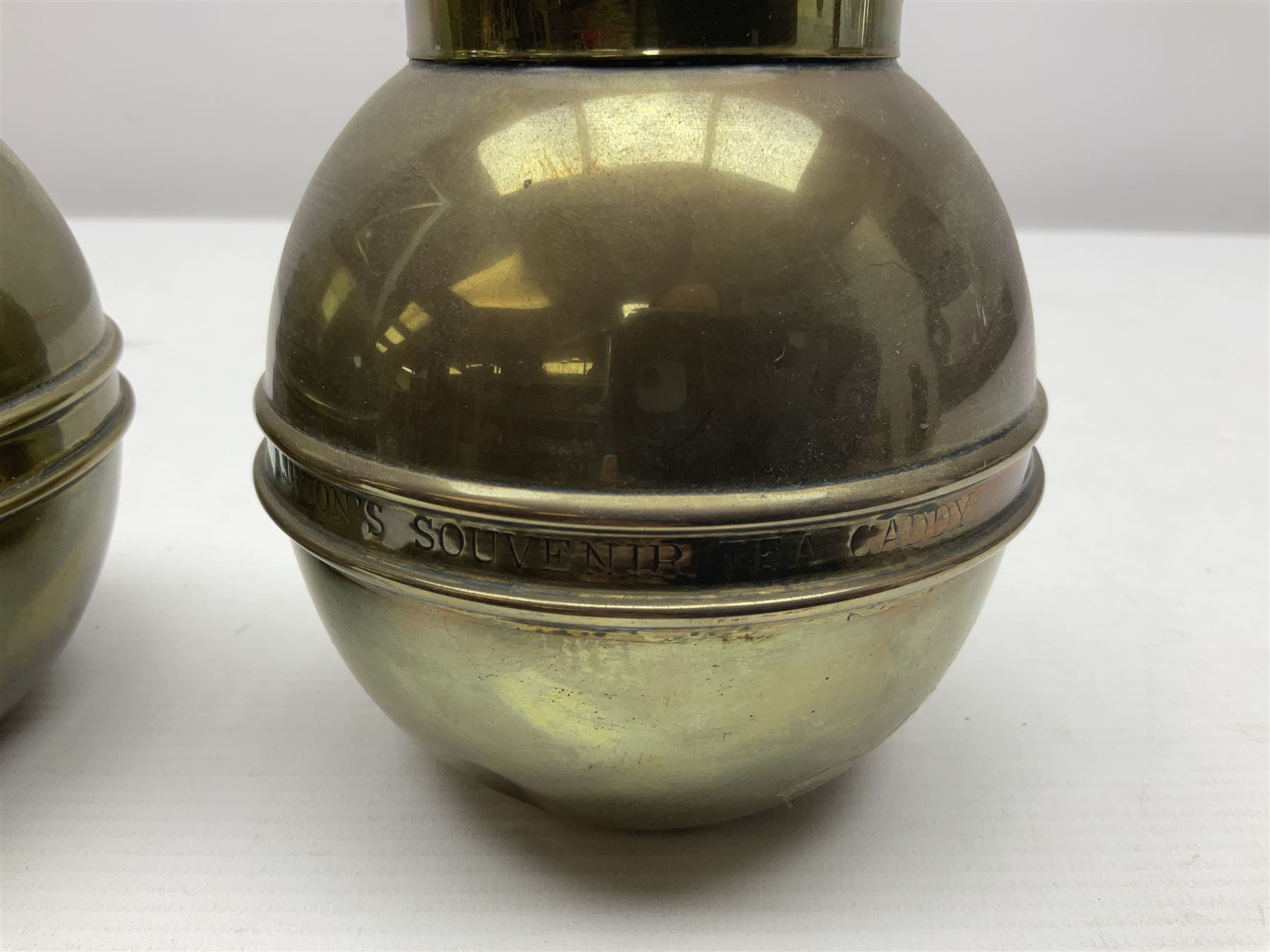 Pair of brass 1924 commemorative tea caddies, of ovoid form the waist embossed with 'British Empire Exhibition 1924' 'Lipton's Souvenir Tea Caddy', H18cm