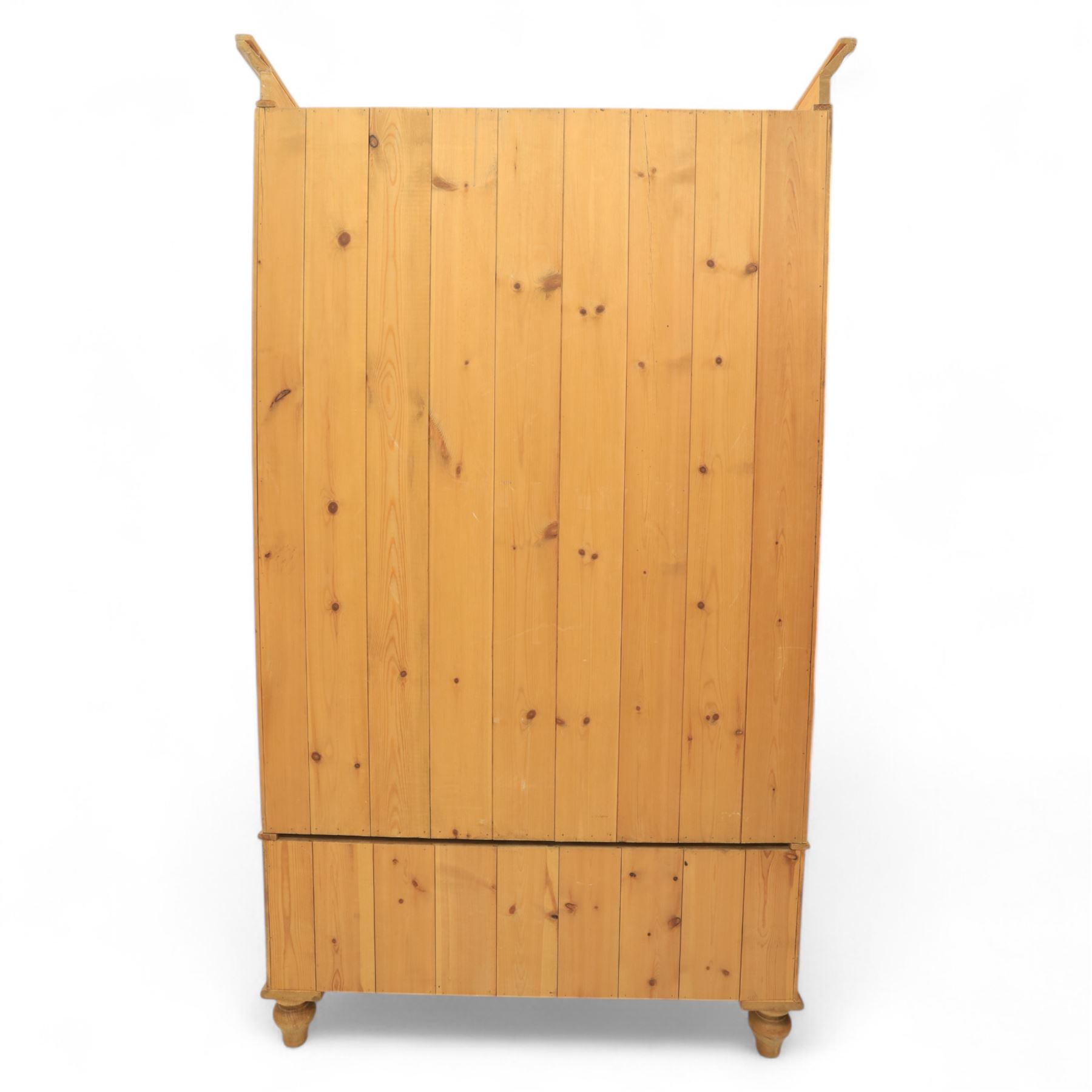 Two contemporary traditional-style wardrobes, projecting plain cornice above two arched moulded panel doors, above a full-width drawer fitted with turned wooden handles, raised on turned bun feet