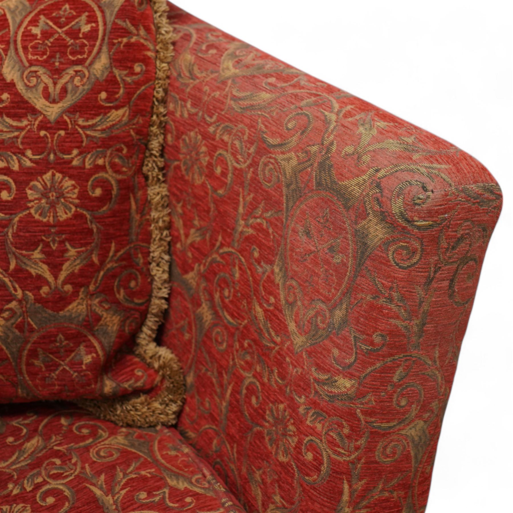 Large Knole design hardwood-framed three-seat drop-arm sofa, upholstered in crimson fabric decorated with trailing acanthus leaves and shields, together with scatter cushions 