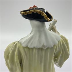 18th century Meissen figure of a Avvocato or the Lawyer from the Commedia Dell'arte series, circa 1740-45, modelled by J J Kandler, wearing gilt edged black tricorn hat, white mask, and yellow cape adorned with red rosettes, holding a scroll in his right hand, upon shaped oval base, no visible mark, H14.5cm