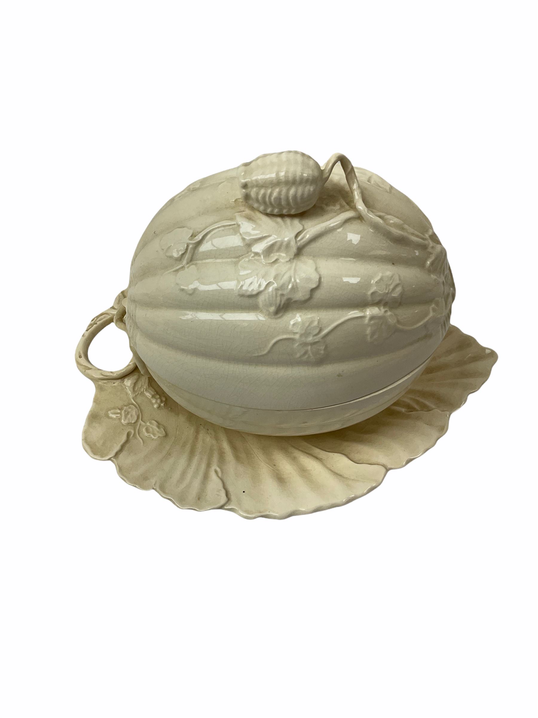 20th century Leeds creamware, comprising chestnut basket and stand, small tureen and cover, ladle, and associated stand, candlestick with stem modelled as a dolphin, teapot, tureen and cover in the form of a melon with fixed stand, and toast rack (toast rack a/f), each with impressed mark beneath. 