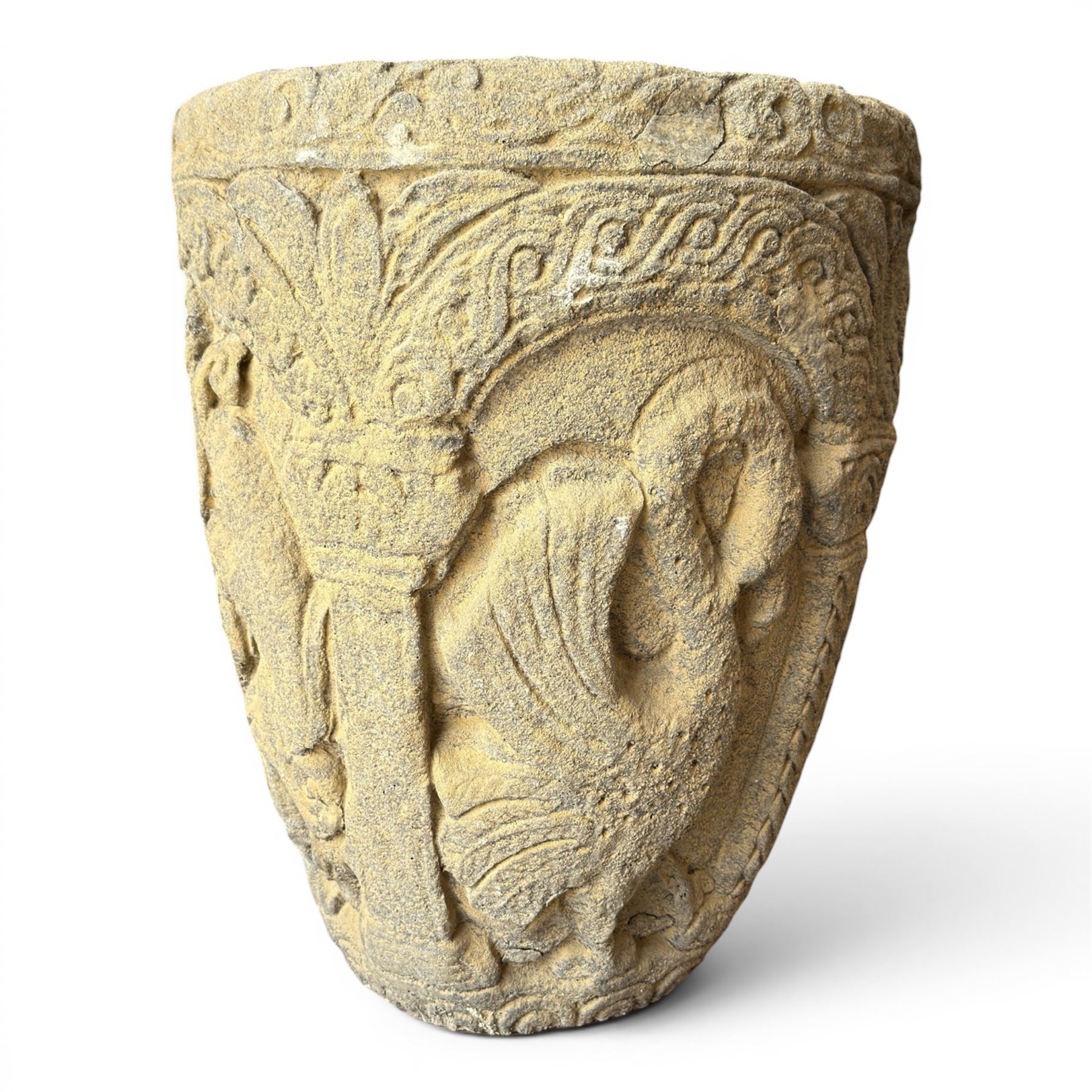 Cast stone Romanesque design urn of tapering form, decorated in relief with motifs of zoomorphic figures and swans within foliate and guilloche cast architectural arches with Neoclassical columns, in weathered finish