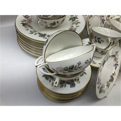 Royal Worcester June Garland pattern tea and dinner wares, comprising thirteen dinner plates, twelve dessert plates, twelve side plates, six twin handled soup bowls and six saucers, six small bowls, sauce boat and stand, thirteen teacups and fifteen saucers, open sucrier, and milk jug
