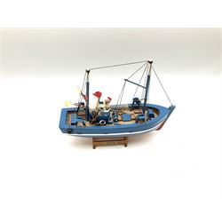 Wooden model of RMS Titanic, on a fixed black stand bearing plaque inscribed 'Titanic 1912', L54cm, H22cm, together with model of a sloop, gaff rigged on stand bearing plaque inscribed 'Sloop' L32cm, H42cm; and model of a fishing trawler on a stand bearing plaque inscribed 'Chalutier' L35cm, H28cm (3)