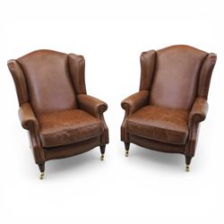 Laura Ashley - Pair of brown leather wingback armchairs, with scrolled arms and loose cush...