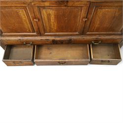 18th century oak hall cupboard, rectangular top with moulded edge, over two panelled hutch-cupboards, the base fitted with six assorted drawers, on large bracket feet
