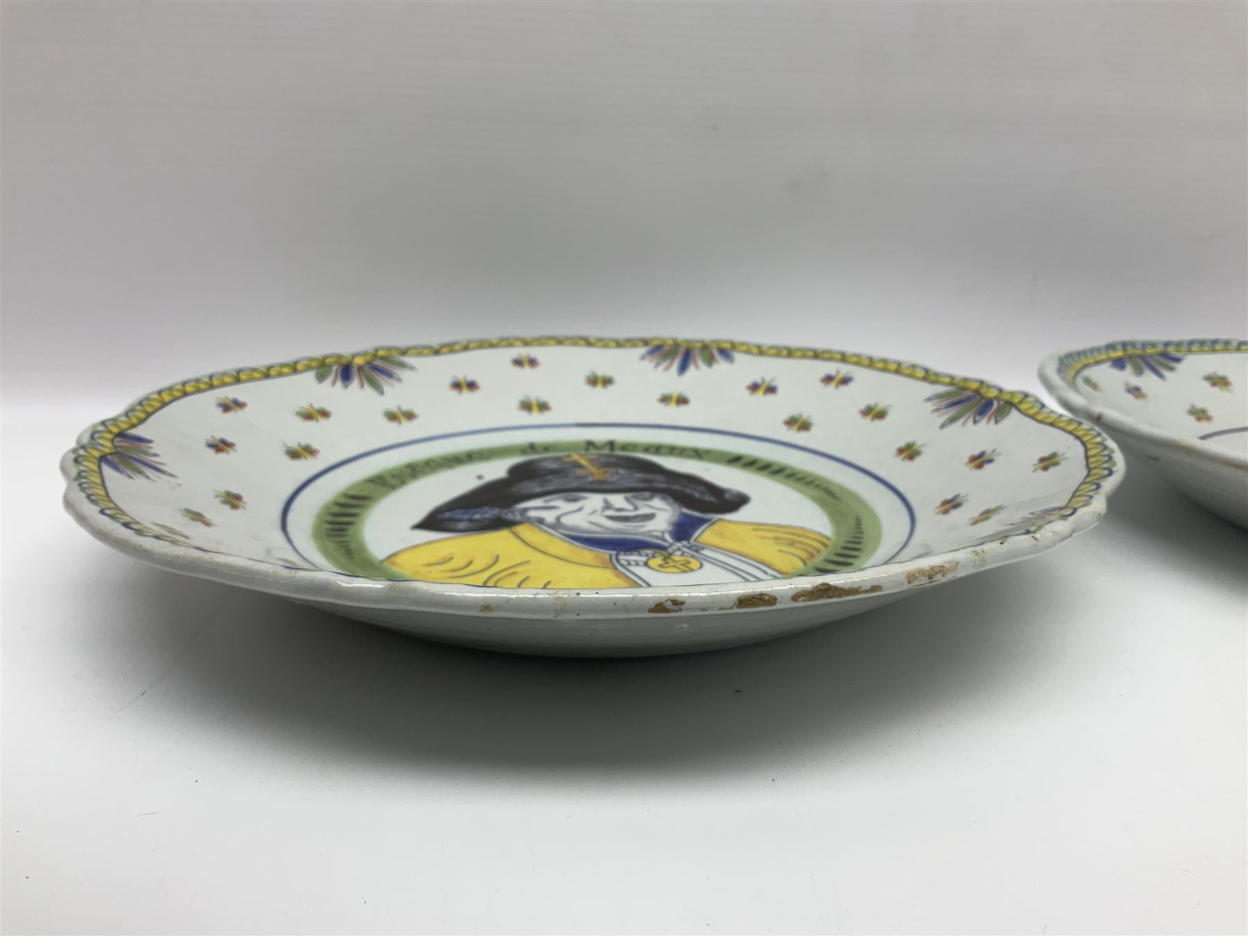 Four French Faience plates, comprising Je suis las de le porter, Le malheur nous reunit, Je desire y arriver and Eveque de Meaux, D24cm  