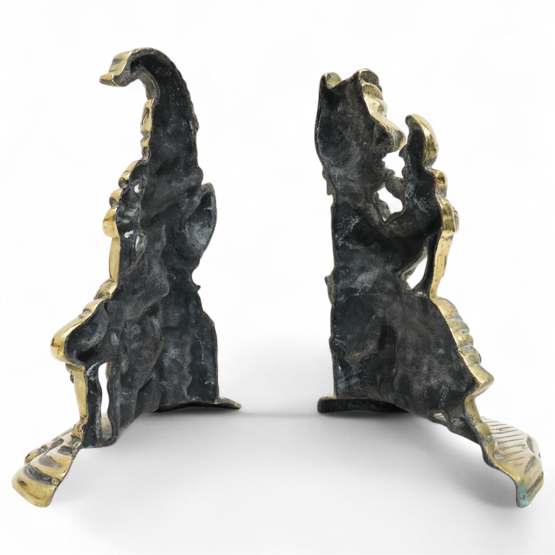 Early 20th century brass 'Mr Punch' doorstop H29cm, another 'Judy' H28cm, pair of brass Jack of Diamonds brass candlesticks H36cm, two other candlesticks and a chamber stick (7)