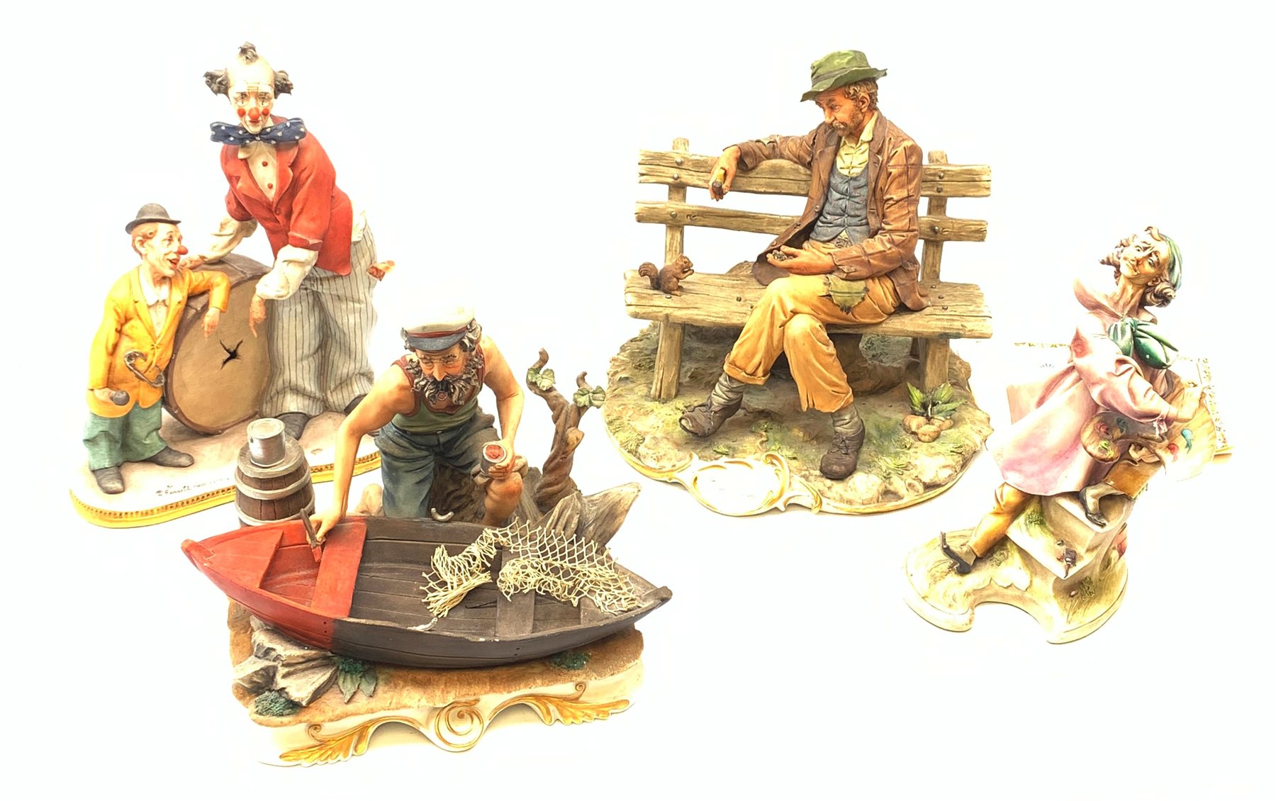 A group of four Capodimonte figurines, comprising The Fisherman, Tramp on Bench, each with accompanying certificate, and two others, one modelled as two clowns leaning against a broken drum, the other modelled as a painter.