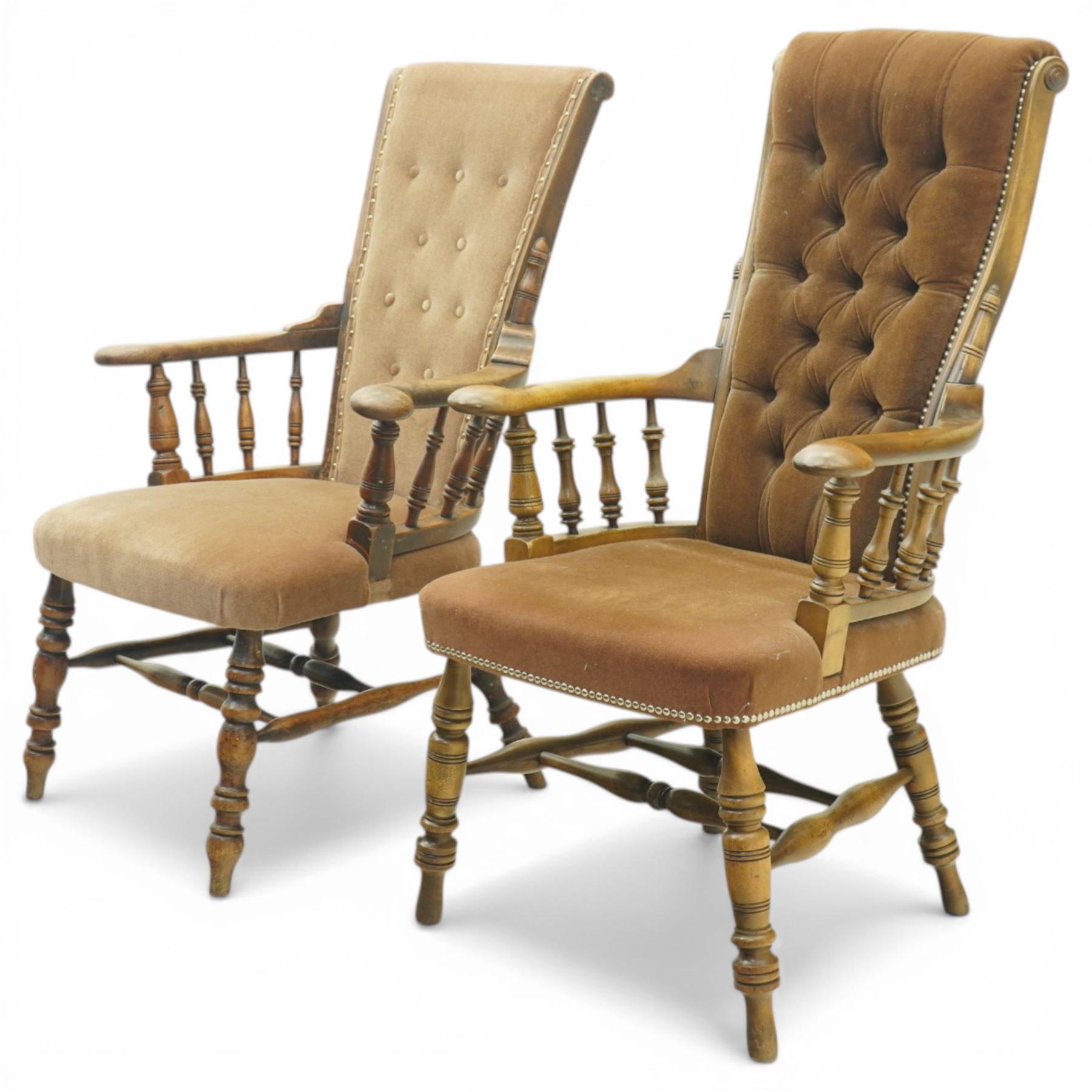 Near pair of late 20th century oak high back armchair, upholstered in brown fabric with buttoned back and close-nailed borders, shaped arms on turned supports, over a stuff-over seat, raised on turned legs united by stretchers