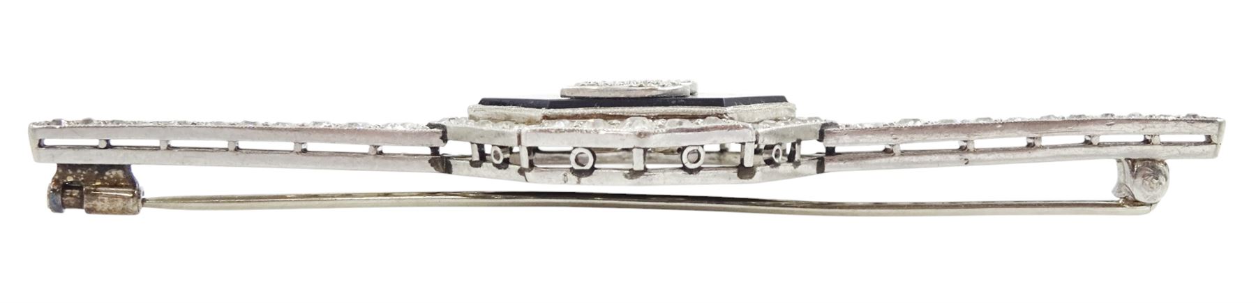 Early 20th century platinum black onyx and diamond initial brooch, single hexagon shaped black onyx with applied diamond set J, with a milgrain set, old cut diamond surround and bars, total diamond weight approx 0.95 carat