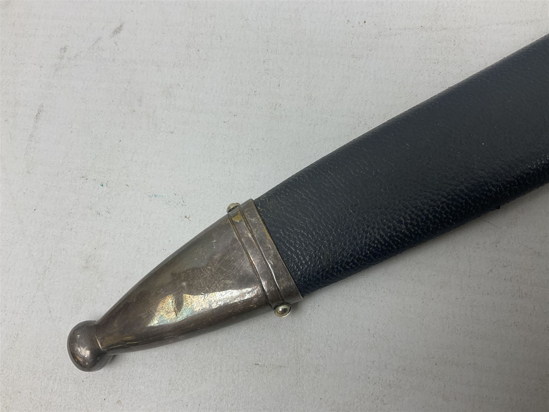 German Paul Weyersberg & Co Solingen DLV flyers dagger with 18cm steel blade, plated brass/tombac downswept cross-piece and pommel and leather covered grip, in leather and plated brass/tombac scabbard with leather hanger strap and silvered knot L35cm overall. Auctioneer's Note: After WWI Germany was forbidden an air force by the Treaty of Versailles however the Deutscher Luftsport-Verband (German Air-sport Association) was formed in March 1933 from various sports flying clubs and had branches for aeroplane, gliding and balloon flying. Under cover of the sporting DLV, many future Luftwaffe pilots trained to fly. DLV was embodied with the NSKK in March 1935 and on 1st March 1937 Luftwaffe was formed.