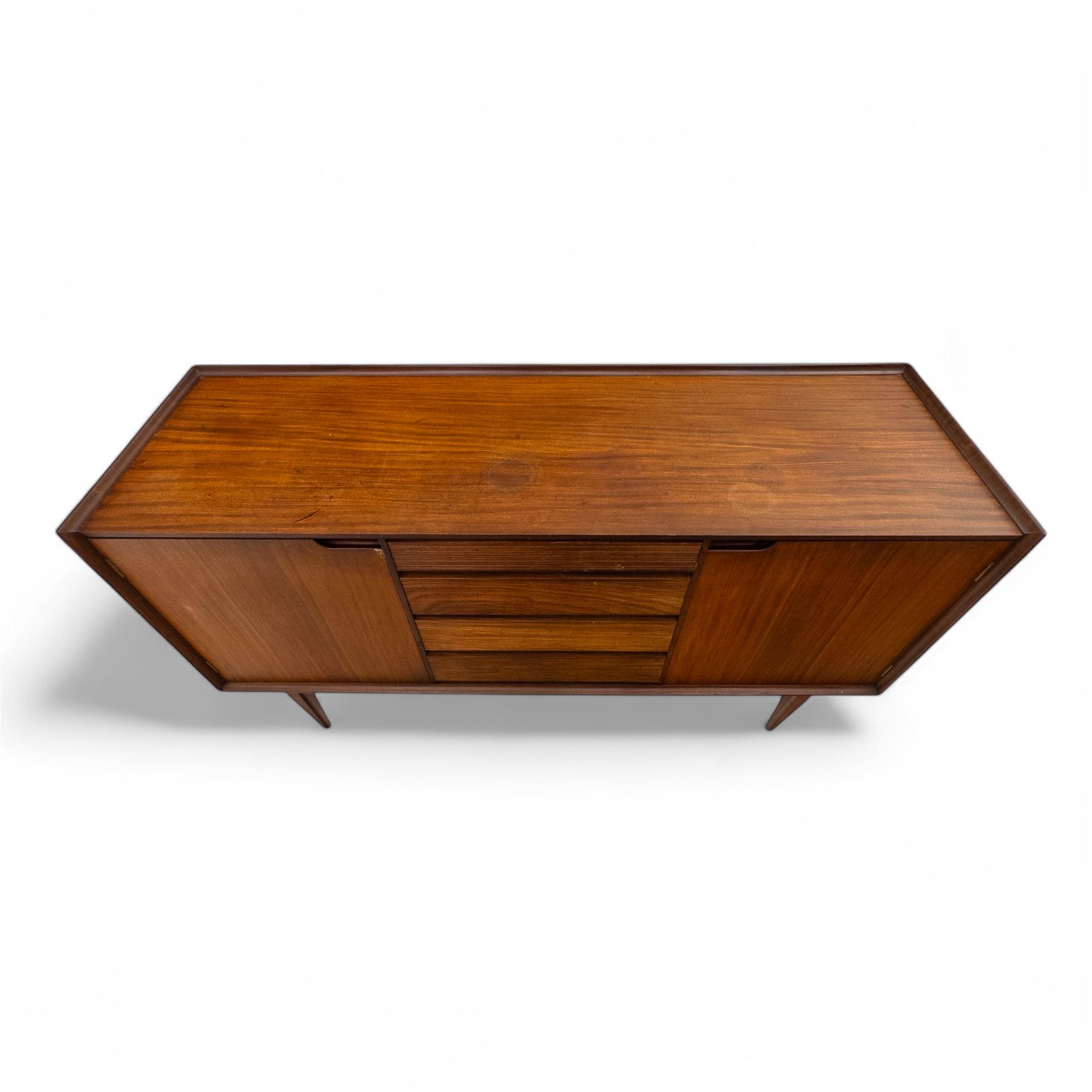 Richard Hornby for Fyne Ladye - mid-20th century afromosia teak sideboard, retailed by Heals of London, rectangular form, with low profile carved gallery lip, above three central drawers with ribbed drawer fronts, flanked by two cupboards with vertically grained doors and recessed pull handles, with streamlined moulded edges and sides, raised on tapered slender legs 