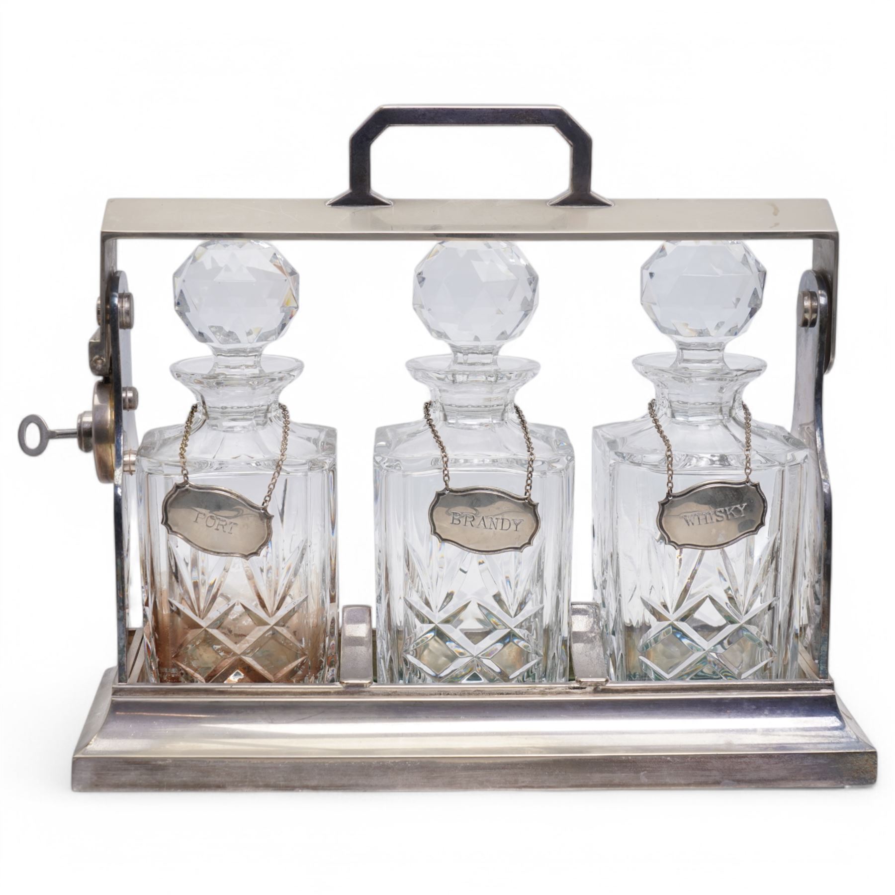 Mappin & Webb silver plated tantalus, with three square glass decanters each with silver plate collars, complete with key, H29cm